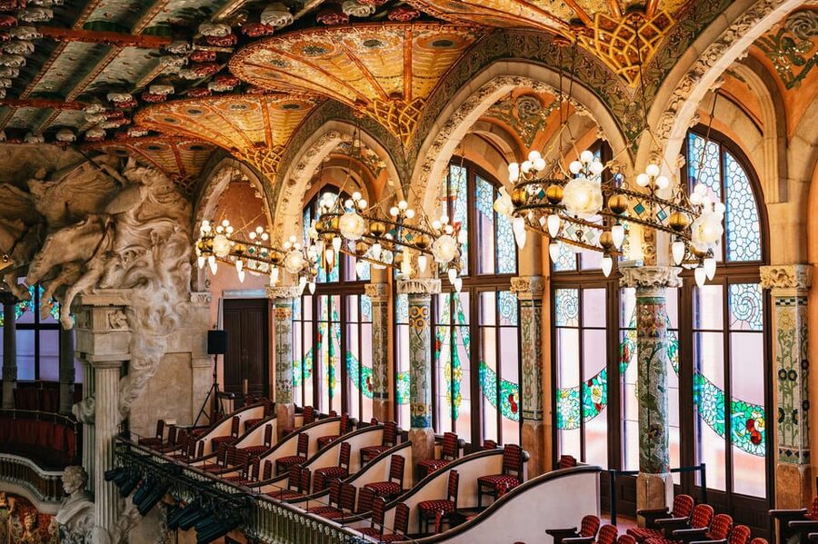 Barcelona: Palau de la Música Guided Tour - The grand staircase, floral designs, and those flags