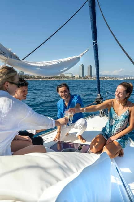 Barcelona: Sailing Tour with Young Local Captain & Drinks - Sailing to Port Vell and Las Ramblas, with yachts and harbor history nearby