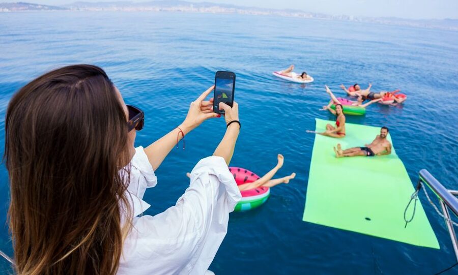 Barcelona: Sunset or Day Catamaran Cruise with Tapa & Drink - Deck setup: sun nets, shade spots, and a calm crowd size