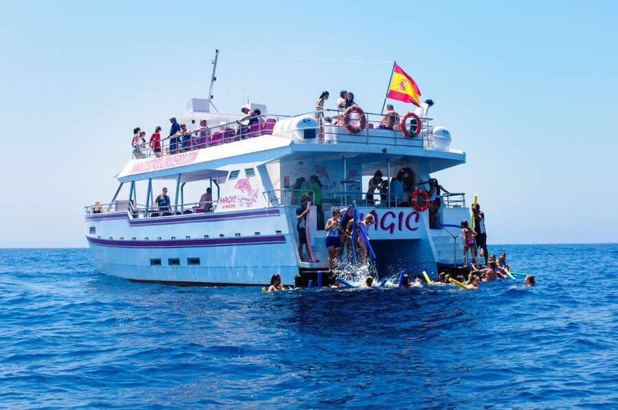 Benalmadena: Dolphin Watching Boat Tour - Coastline views toward Fuengirola: castles, stupa, and a classic bull