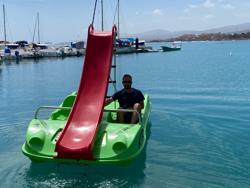Caleta de Fuste: Pedalo with slide rental - Getting set up: life jacket, instructor, and a quick safety rhythm