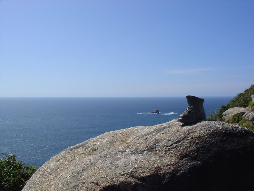 From Santiago: Tour To Finisterre, Muxia & Costa da Morte - Cape Finisterre lighthouse and the 0 Km stone: the symbolic moment