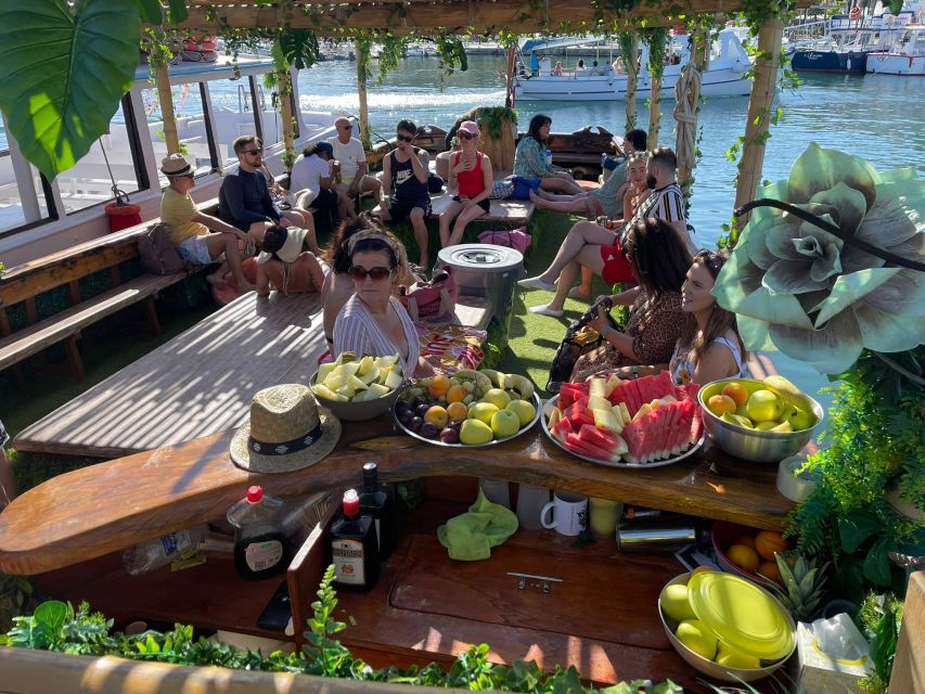 Ibiza: Sea Caves & Coves Snorkeling Paddle Boarding Tour - Boarding the Amazonia Boat: Jungle Decor, a Real Deck, and a Wood Bar