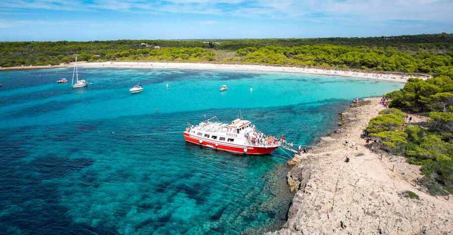 Menorca: Full-Day Boat Tour with Paella Lunch - What the boat day feels like: staff, music, and onboard extras